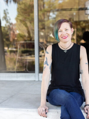 Carrie Lynn Barker sitting in front of a building